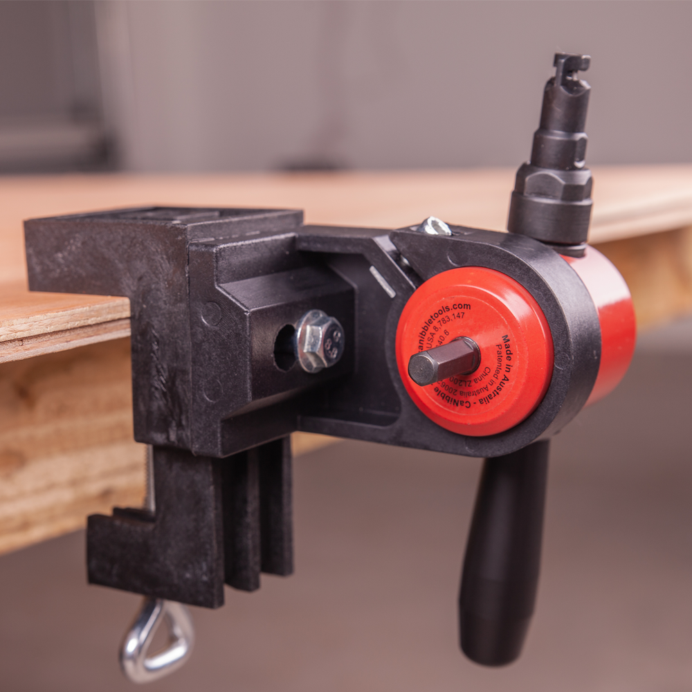 The CaNibble Nibbler mounted in one of it's bench clamps